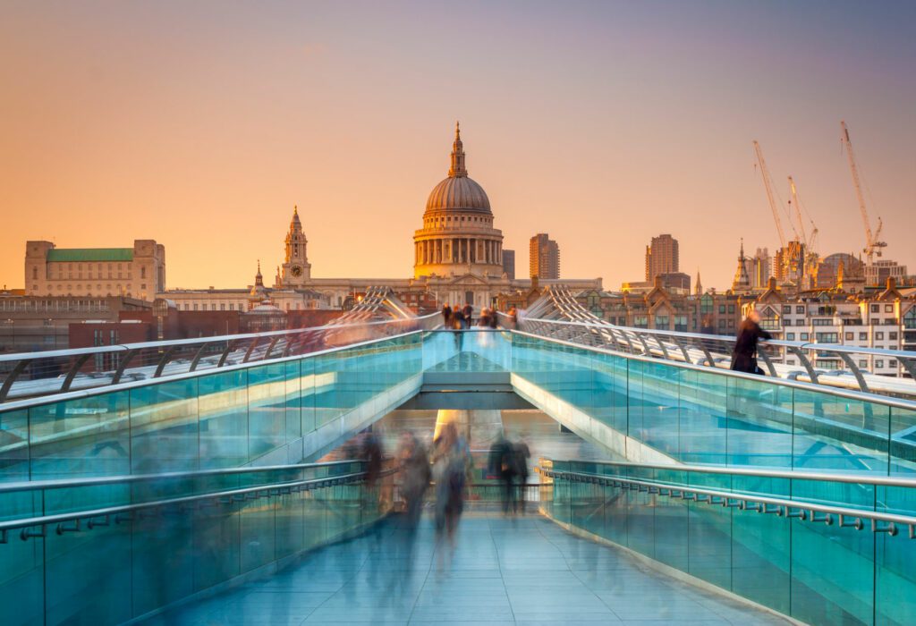 Blurred motion view over the Millennium footbridge looking towards St. Paul's Cathedral at sunset