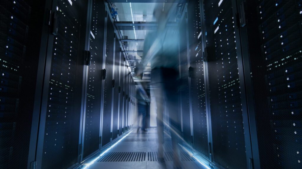 Blurred motion of people walking through server room