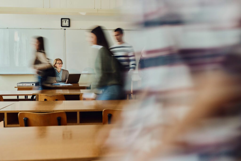 group of students are entering the classroom in blurred motion