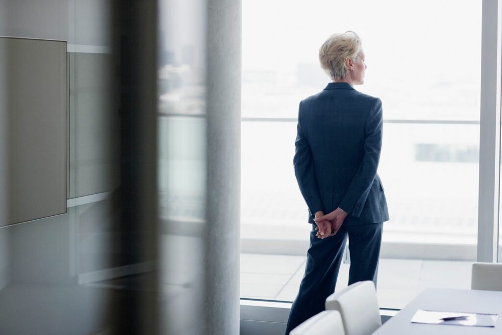 Businesswoman standing at window in office