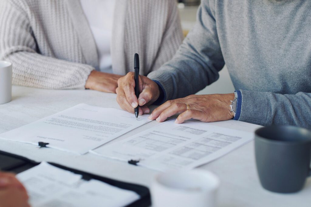 Cropped shot of a senior couple meeting with a consultant to discuss paperwork at home