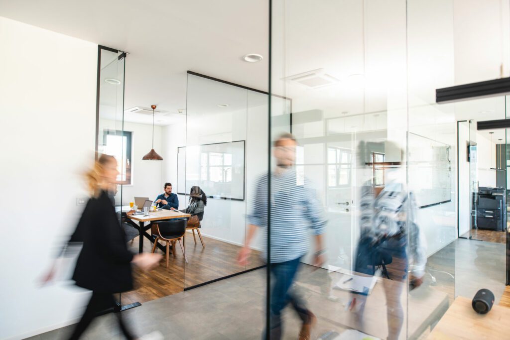 people walking around a bright office